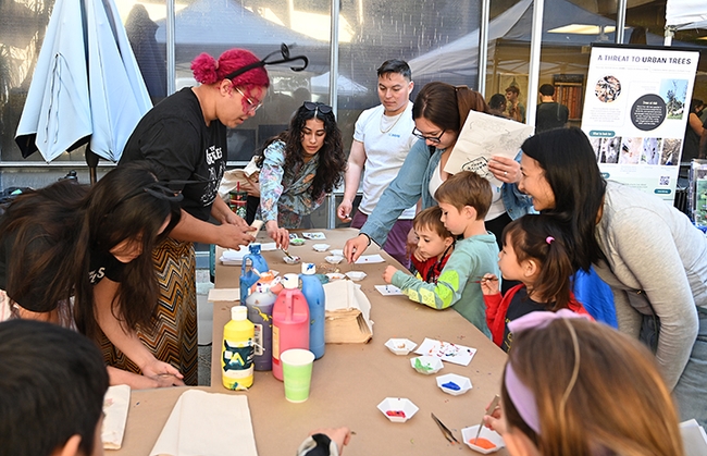 UC Davis doctoral student Iris Quayle of the Jason Bond lab supervises the Maggot Art project, as young artists dip maggots into   water-based, non-toxic paint. (Photo by Kathy Keatley Garvey)
