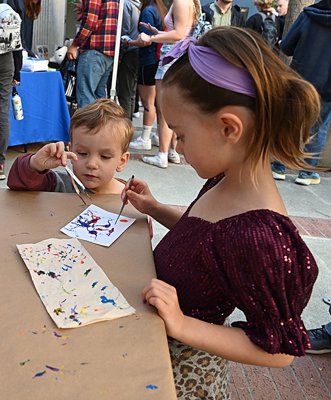 Watson Owens, 2, ponders his Maggot Art project, while his sister, Winter Owens, 5, goes full speed ahead. They drove in from Carmichael to attend UC Davis Picnic Day. (Photo by Kathy Keatley Garvey)