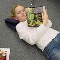 As a third grader, Jill Oberski is stretched out on the floor reading her 