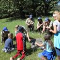 California Conservation Corps members at the UC ANR Hopland Research & Extension Center show a group of kids how to find herpetofauna like salamanders and skinks for a citizen science wildlife monitoring project.