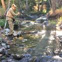 Ariel Dasher (left) and Erik Daniels (right) measure streamflow in the upper Eel River watershed to quantify potential salmon habitat. Photo by Emily Cooper.