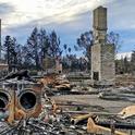 In a Santa Rosa neighborhood, all homes were burned down to the foundations with only things like fireplaces, washer dryer sets, and car frames left. Photo by Faith Kearns.