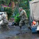 California National Guard members wade through mud to people trapped inside a Montecito home. Air National Guard photo by Senior Airman C. Housman.