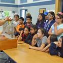 Dr. Sam Sandoval shows afterschool program youth a groundwater model. Photo by Marianne Bird.