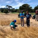 Maggie Reiter with stakeholders on a naturalized area of a golf course. Photo by James Hempfling.