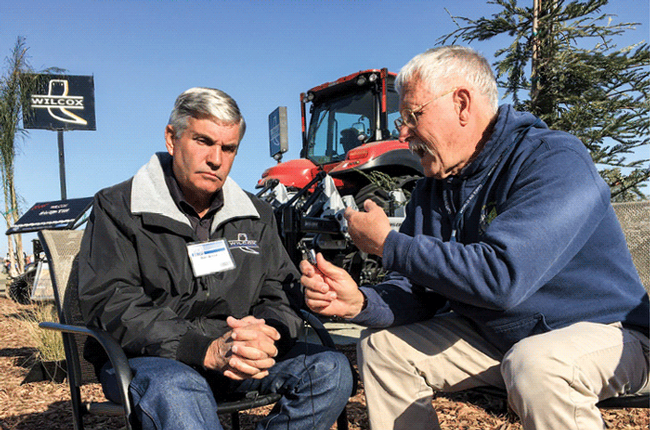 Alan Wilcox, left, and Jeff Mitchell debate the challenges and opportunities for conservation tillage.