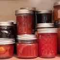 Jars of jams, jellies, and chutneys in a well-stocked pantry. J.C. Lawrence