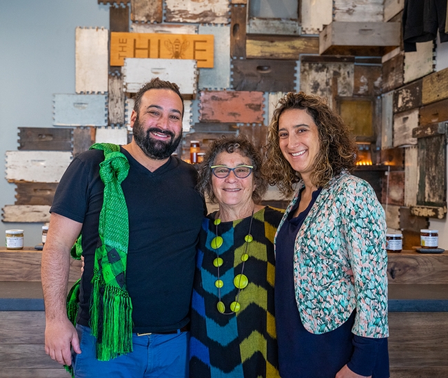 Amina Harris (center) with son, Joshua Zeldner and daughter Shoshi Zeldner at their family-owned and operated business, The HIVE, Woodland. In back are Ishai Zeldner's bee boxes gracing the tasting room.
