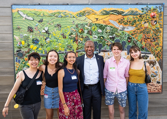 Posing for a group photo with Chancellor Gary May are five mural participants. From left are Kerry Lin, Sierra Deaver, Alia Tu, Chancellor May, Zoe Meilandt and Lily Nugent. (Photo courtesy of Jael Mackendorf, UC Davis College of Agricultural and Environmental Sciences)