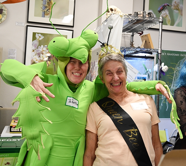 A predator and prey--Tabatha Yang, education and outreach coordinator, dressed as a praying mantis, with 