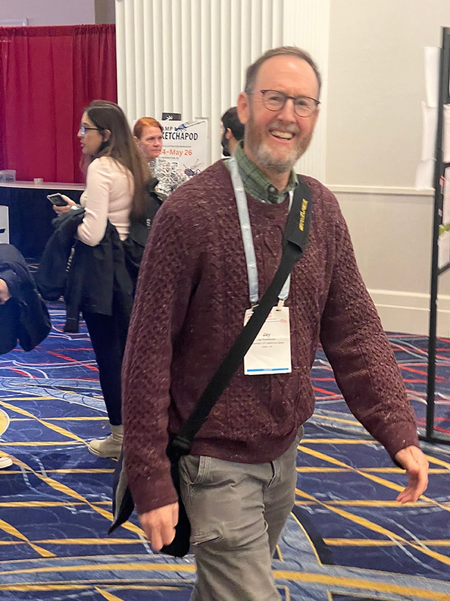 UC Davis distinguished professor Jay Rosenheim of the Department of Entomology and Nematology, weaves his way through the crowd at the Entomological Society of America meeting in National Harbor, Md. (Photo courtesy of Scott Carroll and Jenella Loye)