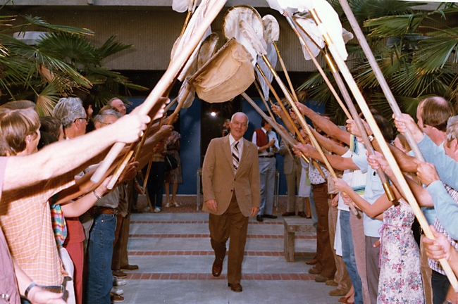 Professor Richard Bohart, founder of the Bohart Museum, walks through the archway of the 21-Net Insect Salute during the museum dedication.
