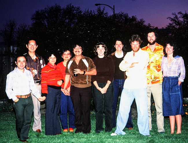 This image depicts Harry Kaya's lab party, circa 1983, in his yard. From lett are Ignacio, Kaya, Raquel Alatorre (doctoral student), Myrtle and (doctoral student) Arnold Hara, an unidentified lab worker,  Phyllis Hotchkin (doctoral student), Hugh Lothrop (lab worker), Robin Goblin-Davis (doctoral student), and Debbie Giblin-Davis.