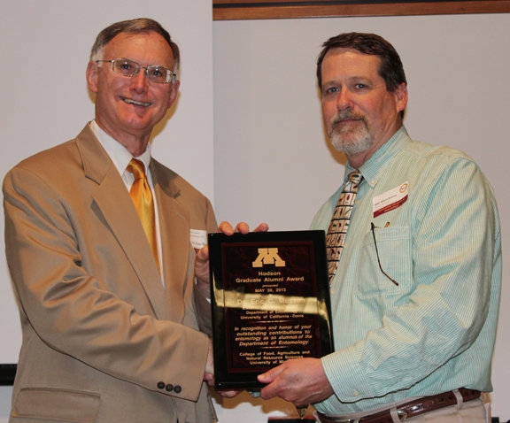 Eric Mussen (left) receives the Alexander Hodson Graduate Alunmi Award from Bill Hutchison, professor and chair of the University of Minnesota's Department of Entomology. (Courtesy Photo