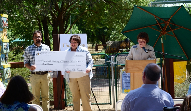 As State Regent Debbie Jamison speaks, her state project chair Karen Montgomery of Modesto and bee scientist Brian Johnson of UC Davis hold the $30,000 check. (Photo by Chris Akins)
