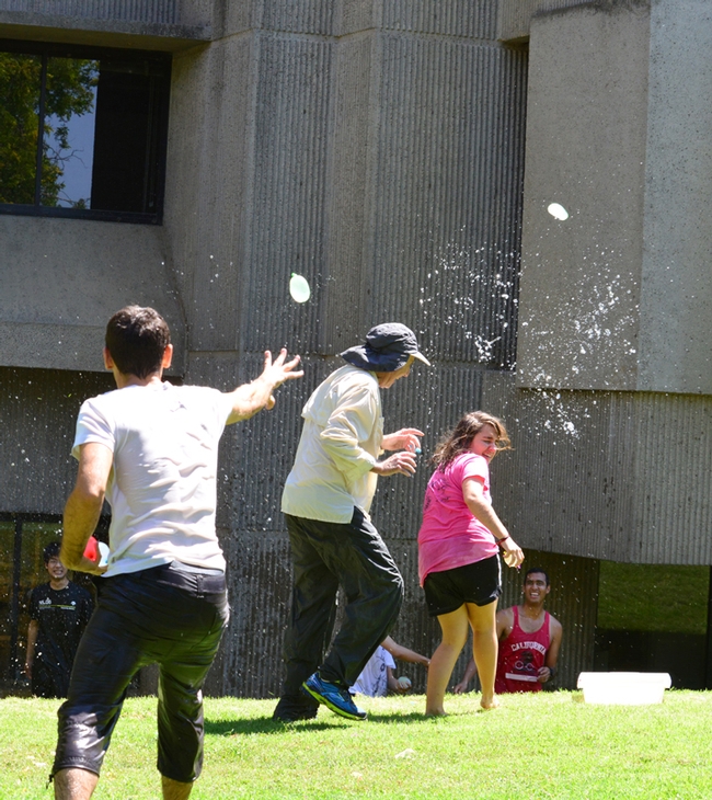 Bogdan Barnych (foreground), a postdoctoral fellow from Ukraine, aims a water balloon at Bruce Hammock. At right is Marina Aguirre, visiting graduate student from France. (Photo by Kathy Keatley Garvey)