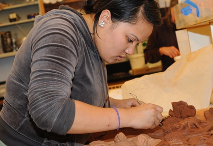 UC Davis honors student Christine Santa Maria works with the clay.