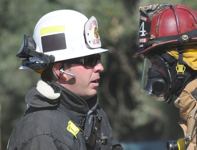 Assistant Chief Nathan Trauernicht (left), operations and training divisions, talks with Fire Captain Nate Hartinger.