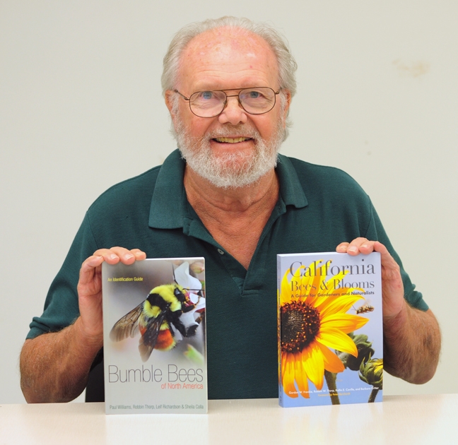 Native pollination specialist Robbin Thorp with two  books he co-authored this year. Both are available in the Bohart Museum of Entomology. (Photo by Kathy Keatley Garvey).