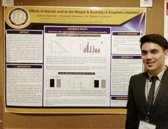 Jadrian Ejercito stands next to his prize-winning poster at the 99th annual meeting of the Pacific Branch, Entomological Society of America.