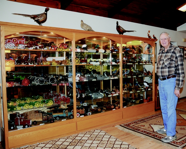 Entomologist/artist Oscar Bacon with his wood carvings; image taken in 2009. (Photo by Kathy Keatley Garvey)