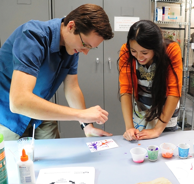 Jered Bell of Vacaville, aerospace engineering student at UC Davis, and Alejandra Wilson of Fairfield, biotechnology major at Solano Community College, try their hand at maggot art.