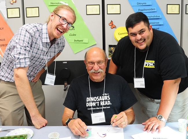 Forensic entomologists (from left) Royce Cumming, Bob Kimsey and Greg Nigoghosian of Purdue in a maggot art activity.