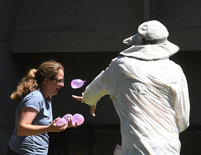 Cindy McReynolds, office manager, Bruce Hammock lab, juggles balloons. At right is Bruce Hammock, who launched the water balloon battle 14 years ago. (Photo by Kathy Keatley Garvey)