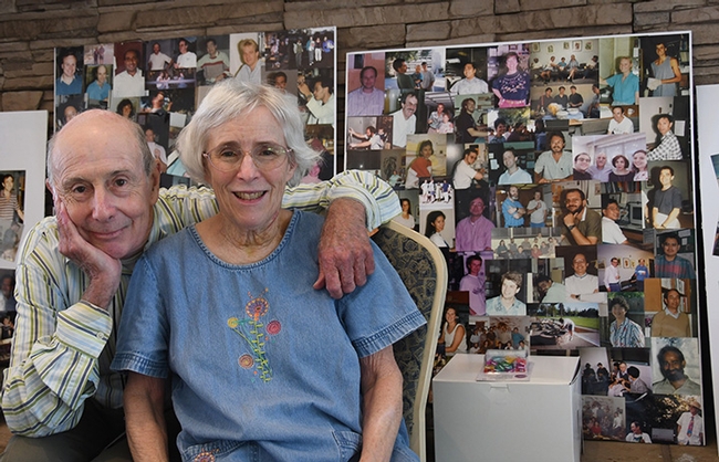 Bruce Hammock and his wife, Lassie, pose for a photo in front of images of his lab alumni. They married in 1972 when both were graduate students at UC Berkeley.(Photo by Kathy Keatley Garvey)