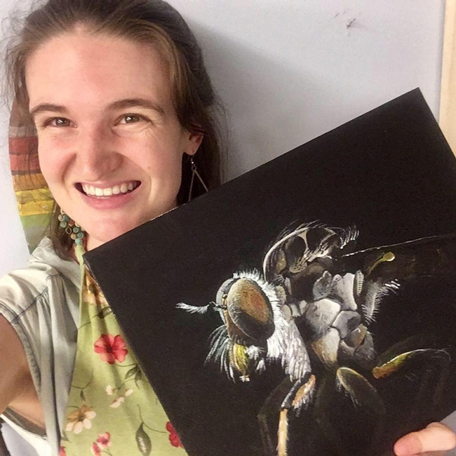 UC Davis fourth-year doctoral student Charlotte Herbert Alberts holds her acrylic painting of an  Assassin fly (Ommatius sp.) that she painted to celebrate World Robber Fly Day, April 30.