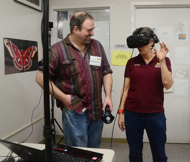 UC Davis medical entomologist Geoffrey Attardo smiles as Lynn Kimsey, director of the Bohart Museum of Entomology and a UC Davis professor, reacts to the virtual reality demonstration on spiders. 