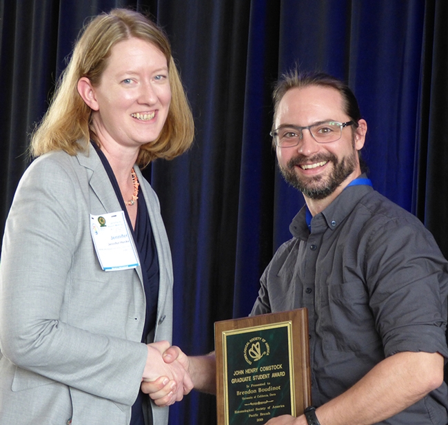 Brendon Boudinot receiving the John Henry Comstock Award earlier this year at a meeting of the Pacific Branch, Entomological Society of America (PBESA). With him is PBESA president Jennifer Henke. He will be honored at the ESA meeting in November in St. Louis. (Photo by Harvey Yoshida)