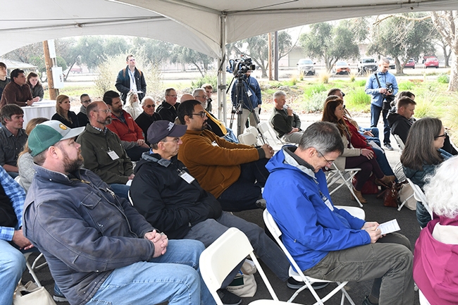 Crowd at the opening of the USDA-ARS lab faciity. In the blue jacket is Professor Neal Williams. Behind him (dark cap) is Steve Nadler, professor and chair of the UC Davis Department of Entomology and Nematology and next to him (on far right) is associate professor Brian Johnson. (Photo by Kathy Keatley Garvey)