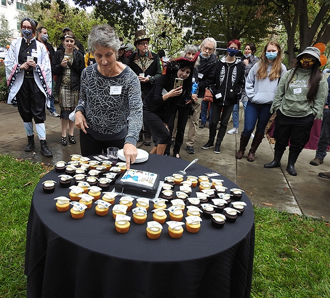 Bohart Museum director Lynn Kimsey cuts the 75th anniversary cake. (Photo by Kathy Keatley Garvey)