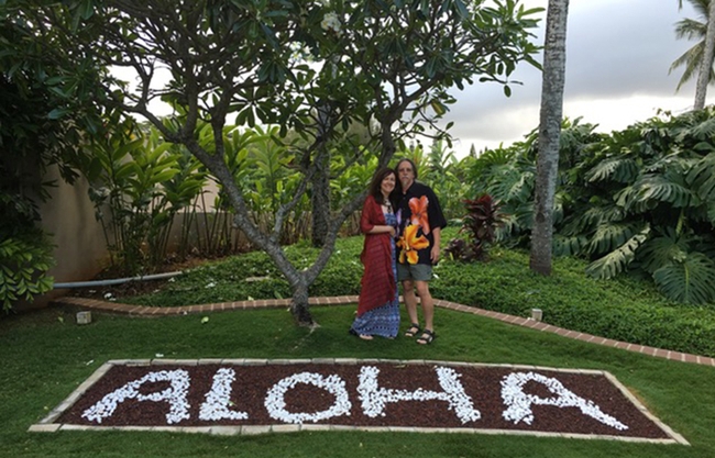 Michael Denison, an internationally known environmental toxicologist, was also known for his love of Hawaii and Hawaiian shirts. Here he and his wife, Grace, stand in front of an Aloha greeting.