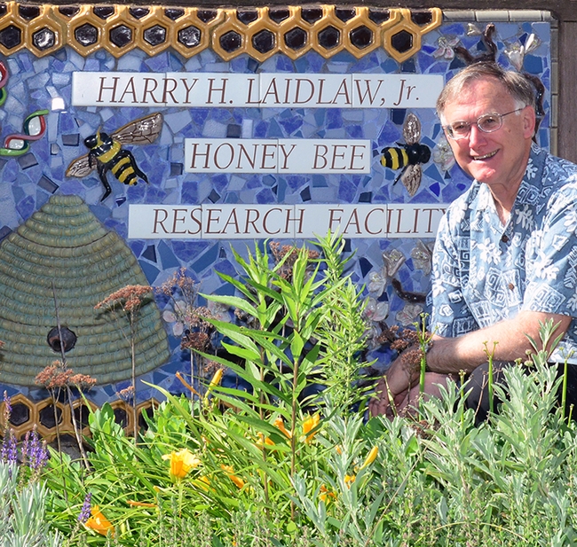 Eric Mussen in front of the Harry H. Laidlaw Jr. Honey Bee Research Facility sign in 2014. (Photo by Kathy Keatley Garvey)