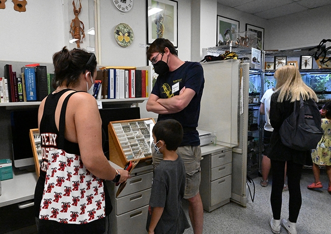 Postdoctoral researcher and Ukraine native Severyn Korneyev of the Bohart Museum of Entomology shows visitors specimens of spider wasps  and small-headed flies. (Photo by Kathy Keatley Garvey)