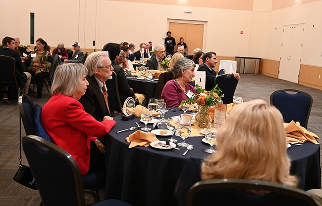 Bill Patterson and his wife, Doris Brown (left), listen to the UC Davis College of Agricultural and Environmental Sciences' Award of Distinction program. At right is Lynn Kimsey, director of the Bohart Museum of Entomology. (Photo by Kathy Keatley Garvey)