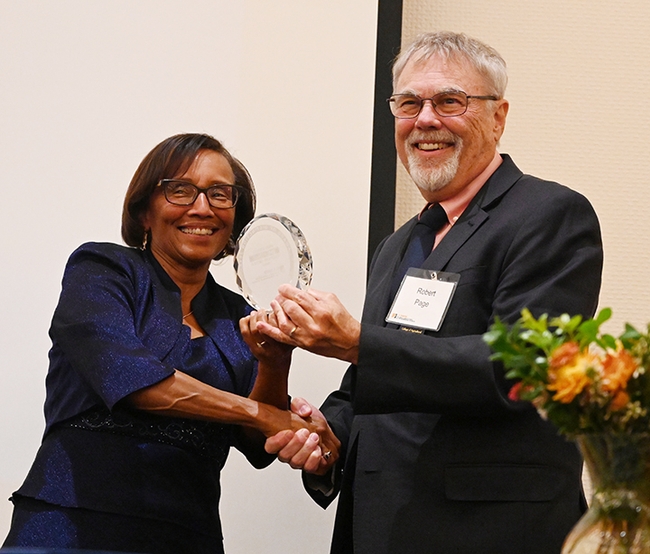 Helene Dillard, dean of the UC Davis College of Agricultural and Environmental Sciences, presents the Exceptional Emeriti Faculty Award to honey bee geneticist Robert E. Page Jr. (Photo by Kathy Keatley Garvey)