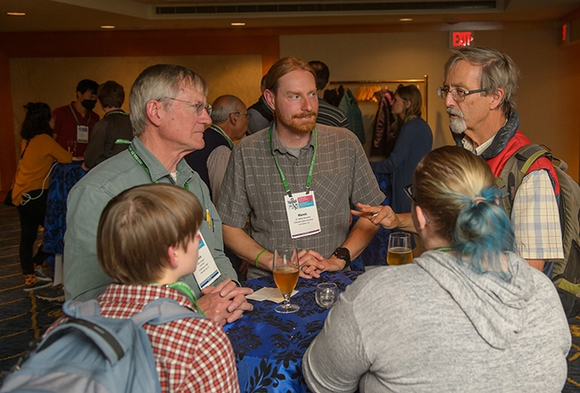 Phil Ward (far right), UC Davis professor of entomology, converses with Ward lab alumnus (2016) Marek Borowiec (center), an assistant professor at Colorado State University. (ESA Photo)