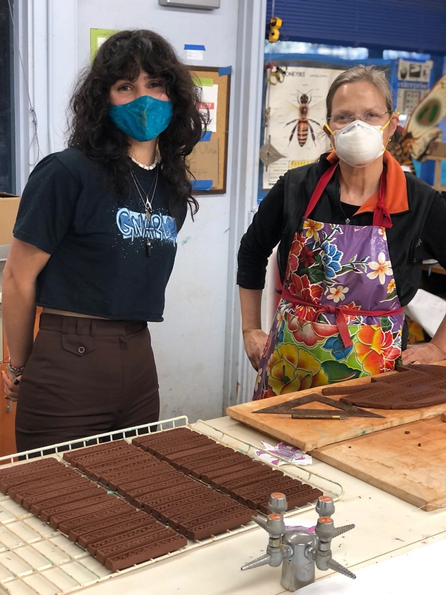 UC Davis student Sydney Lizarde  (left) and community member Sarah Rizzo just finished making trim pieces cut from slabs of clay.