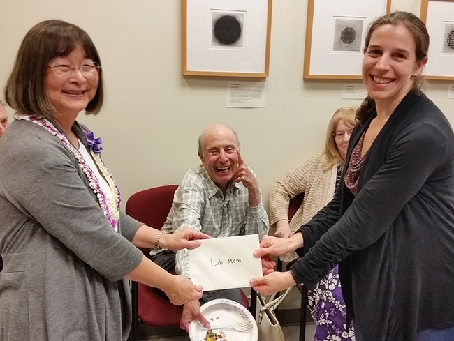 In this 2015 image, taken at the International Chemical Congress of Pacific Basin Societies meeting in Honolulu, researcher Candace Spier Beaver (right) presents a card to retiring toxicologist Shirley Gee of the Hammock Lab. In the center are Bruce Hammock, UC distinguished professor, and Jeanette Van Emon.