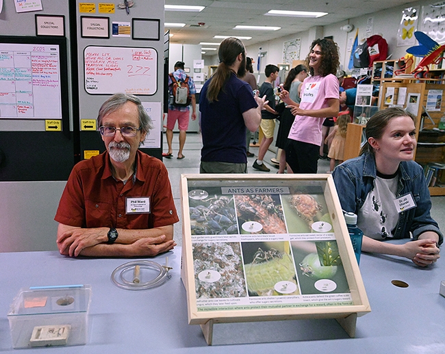 UC Davis professor Phil Ward and lab member Jill Oberski, greet guests at the Bohart Museum open house. In the center is a display on 