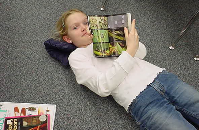 Insects have fascinated Jill Oberski since childhood. In this  image, taken in her third-grade classroom, she is reading her book, 
