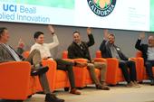 Darren Haver (center) and fellow roundtable participants raise their hands when asked the question, 