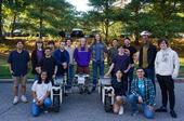 Students pose with their advisor next to the agricultural robot they designed