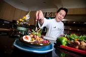 Celebrity chef Martin Yan puts the finishing touch on a Chinese dish.