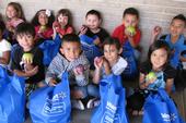 Kids enjoying fresh fruit at Roosevelt Elementary School. (Photo: Flora Welch )