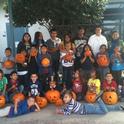 UC nutrition educator Grilda Gomez, back row far right, poses with the students and their jack-o-lanterns.