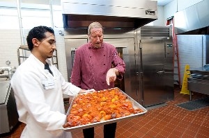 Chef Bob Walden, right, and Arnulfo Herrera, a cook, show off the roasted goodness. (photo: Gregory Urquiaga / UC Davis)